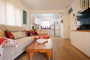 a living room with a couch and a coffee table at Villa Flamboyán Meloneras in Meloneras