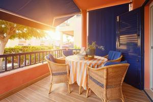a balcony with a table and chairs on a balcony at Villa Flamboyán Meloneras in Meloneras +45 photos