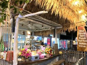 a store with flowers on a counter in a store at Ong Lang Cozy House with pool - 500m to the beach in Phu Quoc
