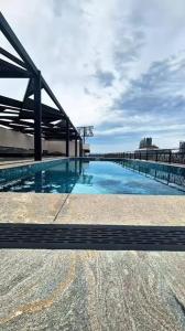 a large swimming pool on top of a building at Spacious Studio with UPS, across Giga mall, Pool included in Islamabad +11 photos
