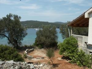 a house with a view of a body of water at Secluded fisherman's cottage Krknata, Dugi otok - 399 in Žman