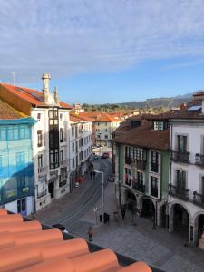 a view of a street in a city with buildings at La plaza de llanes, Plaza Parres Sobrino, 6 in Llanes
