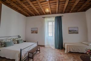 a bedroom with two beds and a window at Casale Malatesta in Velletri +10 photos