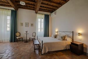 a bedroom with a bed and a table and chairs at Casale Malatesta in Velletri