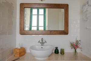 a bathroom with a sink and a mirror at Casale Malatesta in Velletri