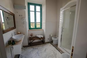a bathroom with a sink toilet and a window at Casale Malatesta in Velletri
