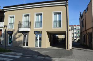 a large building with a garage in front of it at OFF 32 Suites in Melzo