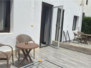 a patio with chairs and a table and a table and chairs at Alma & Thiago House in Sharm El Sheikh