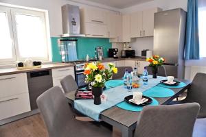 a kitchen with a table with flowers on it at FLH - MIG Loft Sibiu in Cisnădie