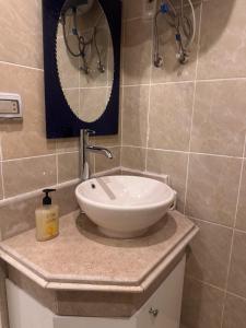 a bathroom with a sink and a mirror on a counter at Alma & Thiago House in Sharm El Sheikh +1 photo