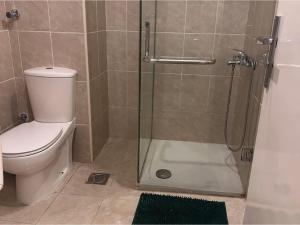 a bathroom with a toilet and a glass shower at Alma & Thiago House in Sharm El Sheikh