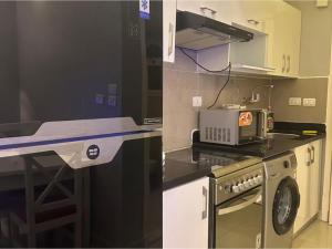 a kitchen with a counter with a stove and a microwave at Alma & Thiago House in Sharm El Sheikh