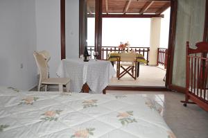 a bedroom with a bed and a table and chairs at Villa Agalianos in Kerames