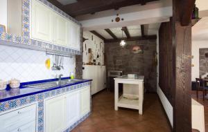a kitchen with a sink and a refrigerator at Villa Mare Panoramica Estia in Brancaleone Marina