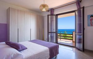 a bedroom with a bed and a view of the ocean at Villa Mare Panoramica Estia in Brancaleone Marina +42 photos