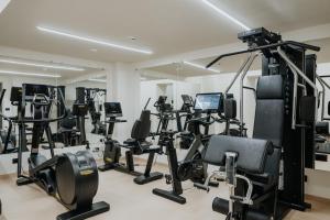 a gym with a bunch of exercise equipment in a room at Hotel Metropole Taormina in Taormina