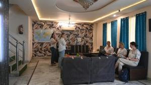 a group of people standing in a living room at Hotel NoVo Agra in Agra