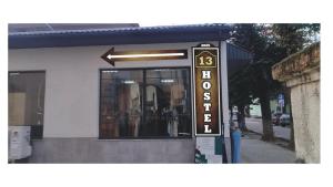 a store sign in front of a building at 13 Hostel in Stryi
