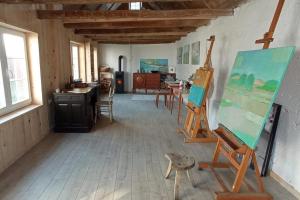 an art room with an easel and a painting at Apartments with parking space Plaski, Velebit - 21935 in Plaški +7 photos