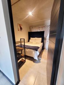 a small bedroom with a bed and a ladder at Home away from home in Midrand +4 photos