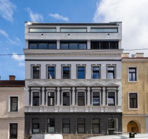 a large white building with a lot of windows at Velvet Vienna - at metro station U1 - 5 mins to opera in Vienna