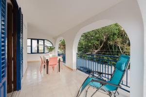 a room with a table and chairs on a balcony at Venti Del Mare in Trappeto