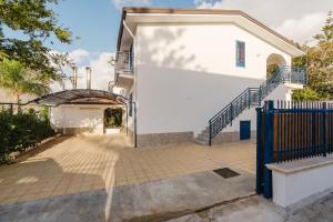 an entrance to a white house with a blue gate at Venti Del Mare in Trappeto