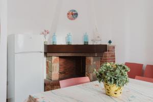 a kitchen with a table with a fireplace at Venti Del Mare in Trappeto