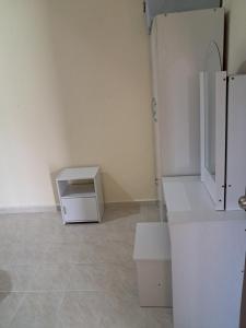 a kitchen with a white refrigerator and a stove at Homestay Kubang Kerian, Kota Bharu in Kota Bharu +16 photos
