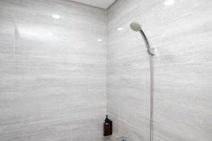 a shower with a shower head in a wall at Sans Vibes Hotel Damai Yogyakarta in Kejayan +62 photos