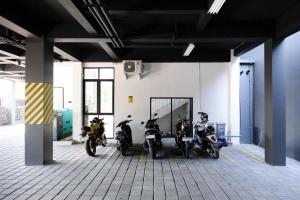 a group of motorcycles parked in a garage at Sans Vibes Hotel Damai Yogyakarta in Kejayan
