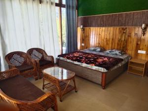 a bedroom with a bed and a table and chairs at Pinaka Devbhumi Homestay in Mukteshwar +3 photos