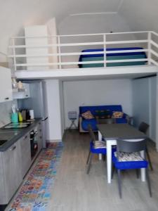 a kitchen with a table and a bunk bed at La Perla del Borgo in Vieste