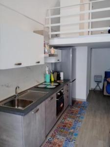 a kitchen with a sink and a stove at La Perla del Borgo in Vieste