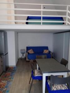 a living room with a couch and a table and a bed at La Perla del Borgo in Vieste