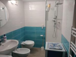 a bathroom with a toilet and a sink and a shower at La Perla del Borgo in Vieste +1 photo