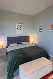 a bedroom with a large bed with a green blanket at Villa Saguramo in Saguramo