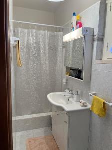 a white bathroom with a shower and a sink at Le Prata 