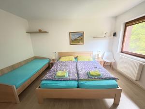 a bedroom with a bed and a window at Triglav NP Apartment - above Bled in Zgornje Gorje