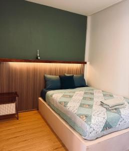 a bedroom with a bed with a wooden headboard at Happiness Hostel Private room in Phra Ae beach +8 photos