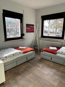 Dos camas en una habitación con dos ventanas. en Amazing entire Apartment, U79&S1, Messe, Airport, Hbf, 6-Seen-Platte, en Duisburg