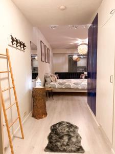 a living room with a bed and a ladder at Warm Wooden Home in Rovaniemi in Rovaniemi