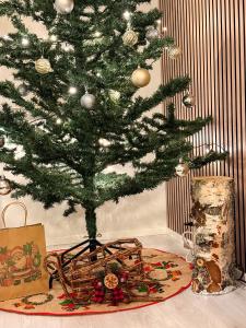 a christmas tree with presents under it on a table at Warm Wooden Home in Rovaniemi in Rovaniemi