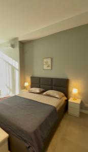 a bedroom with a large bed with two lamps at Villa Saguramo in Saguramo