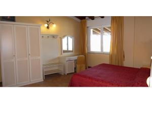 a bedroom with a bed and a dresser and a window at Residence Miralago Rooms & Apartments in Manerba del Garda