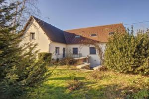 a white house with a brown roof at L'Arbre de Vie in Montmarault