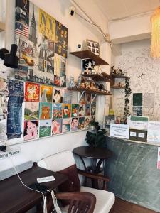 a restaurant with posters on the wall and a table at Happiness Hostel Private room in Phra Ae beach