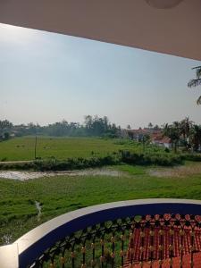 a view of a field with cows in the distance at Dona Helena Holiday Home in Madgaon