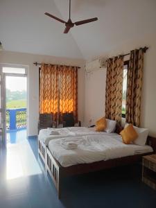 a bedroom with a large bed with a large window at Dona Helena Holiday Home in Madgaon +9 photos