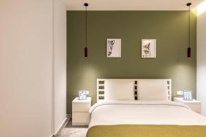 a bedroom with a large bed with green walls at Respiro Rooms in Istanbul